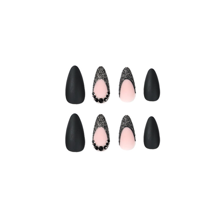 Artful stiletto nails with elegant black design and glitter accents Bowlift