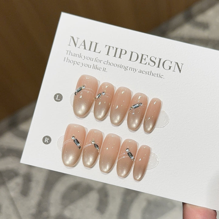 Artificial nail tips with elegant gradient color and rhinestone accents Bowlift