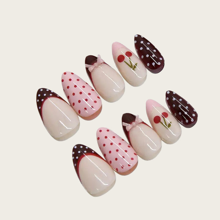 Artfully designed nail tips with cherry and dot motifs Bowlift