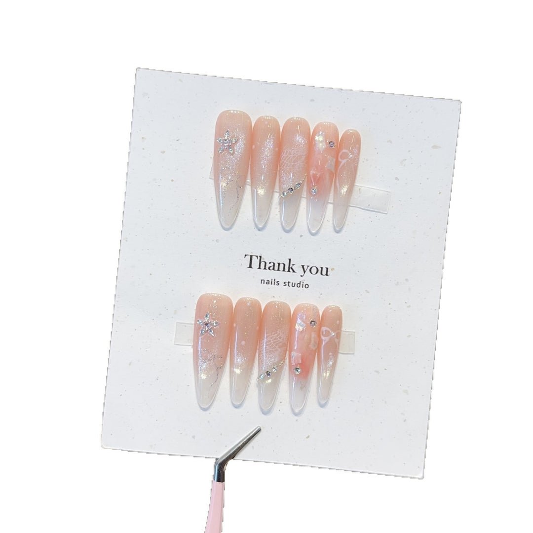 Artificial nails with filigree design and glitter accents Bowlift