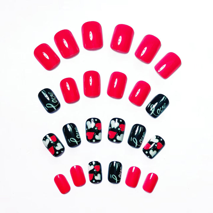 Acrylic nail design with hearts and kiss motifs Bowlift