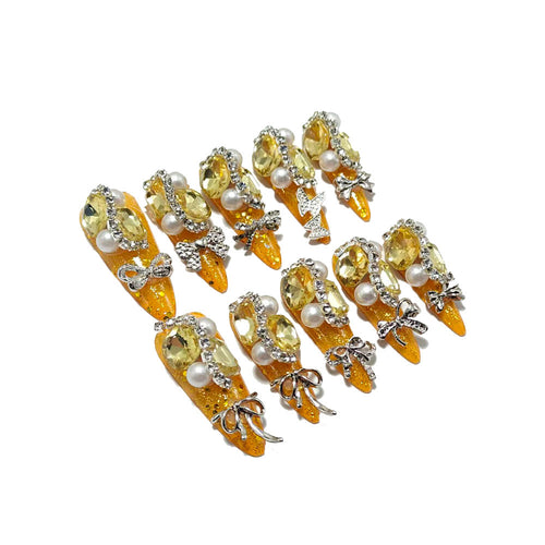 Glamorous artificial nails with rhinestones and pearl embellishments Bowlift