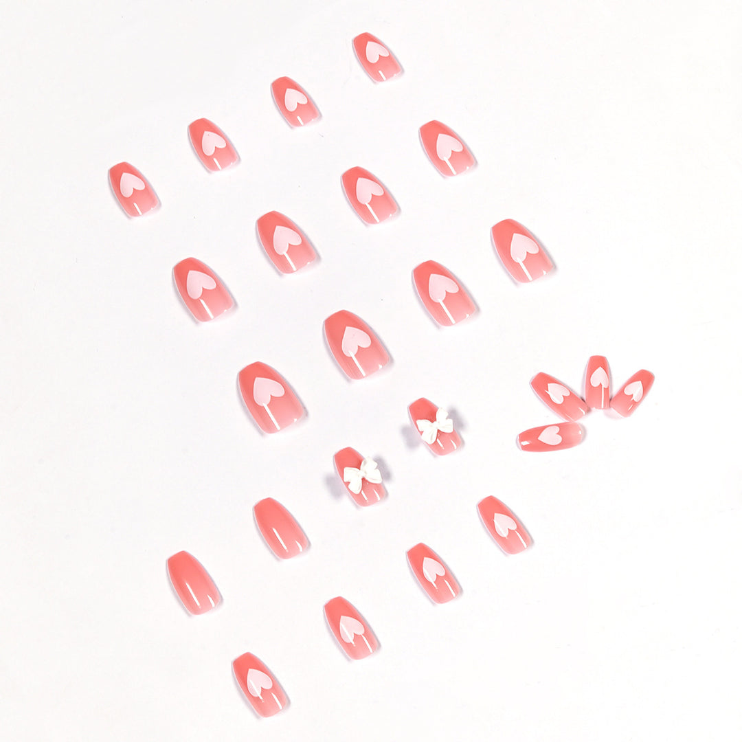 Artistic acrylic nails with heart and bow motifs Bowlift