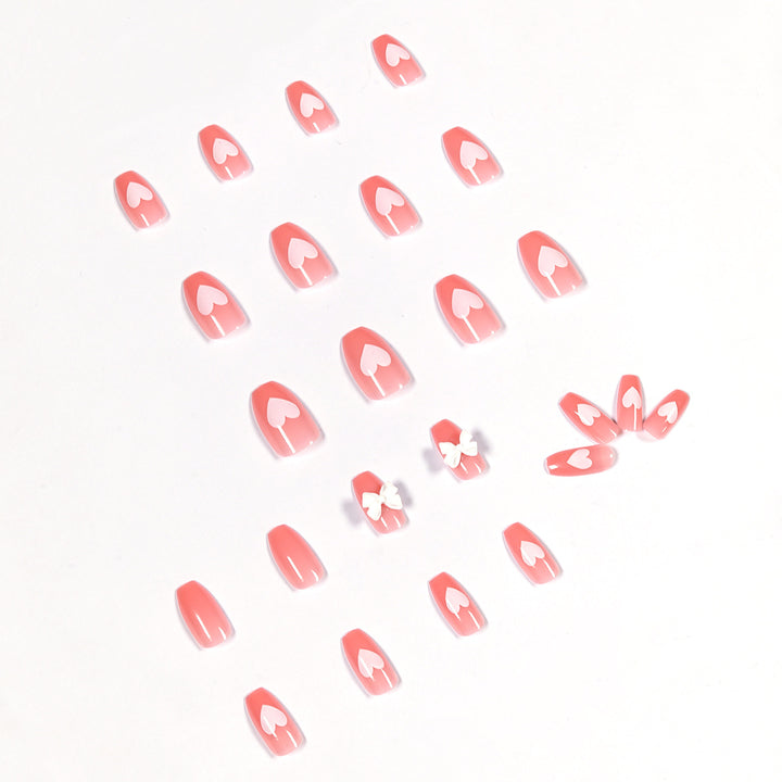 Artistic acrylic nails with heart and bow motifs Bowlift