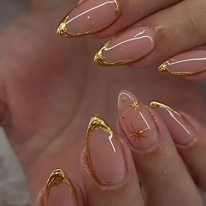 Glamorous stiletto nails with golden accents Bowlift