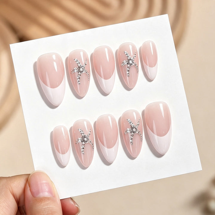 Artificial nail set with delicate pearlescent and glitter accents Bowlift