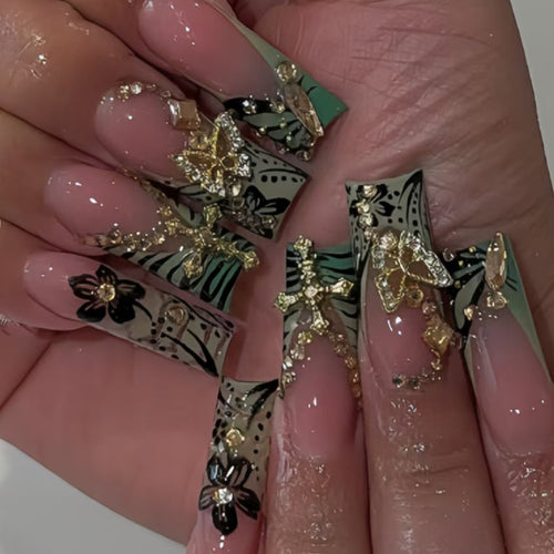 Artistic Stiletto Nail Design with Floral Accents and Gems Bowlift