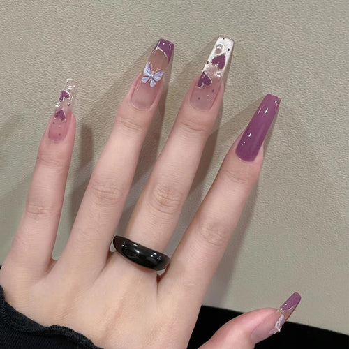 Artistic Press-On Nail Design with Butterfly Accents Bowlift