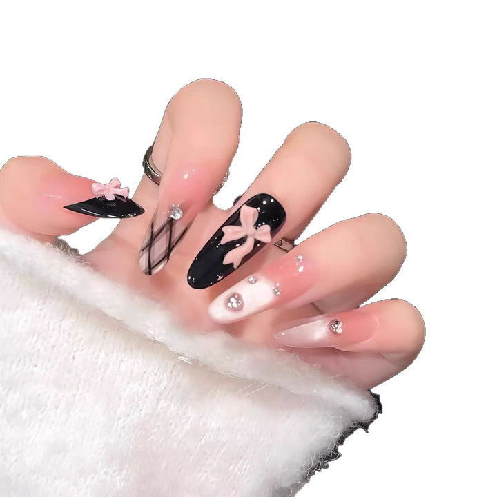 Artificial nails with playful bow and glitter accents Bowlift