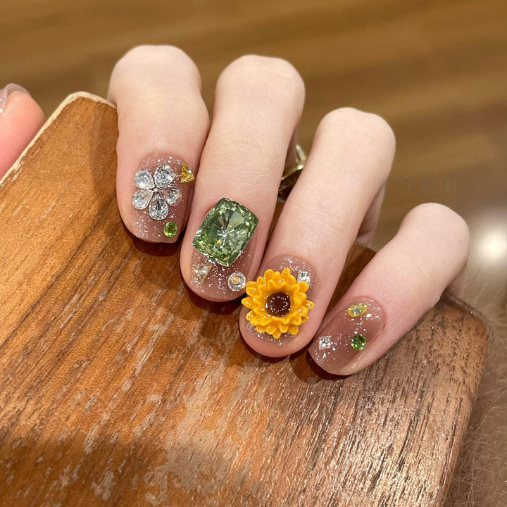 Artificial nails with sparkling appliqués and floral designs Bowlift