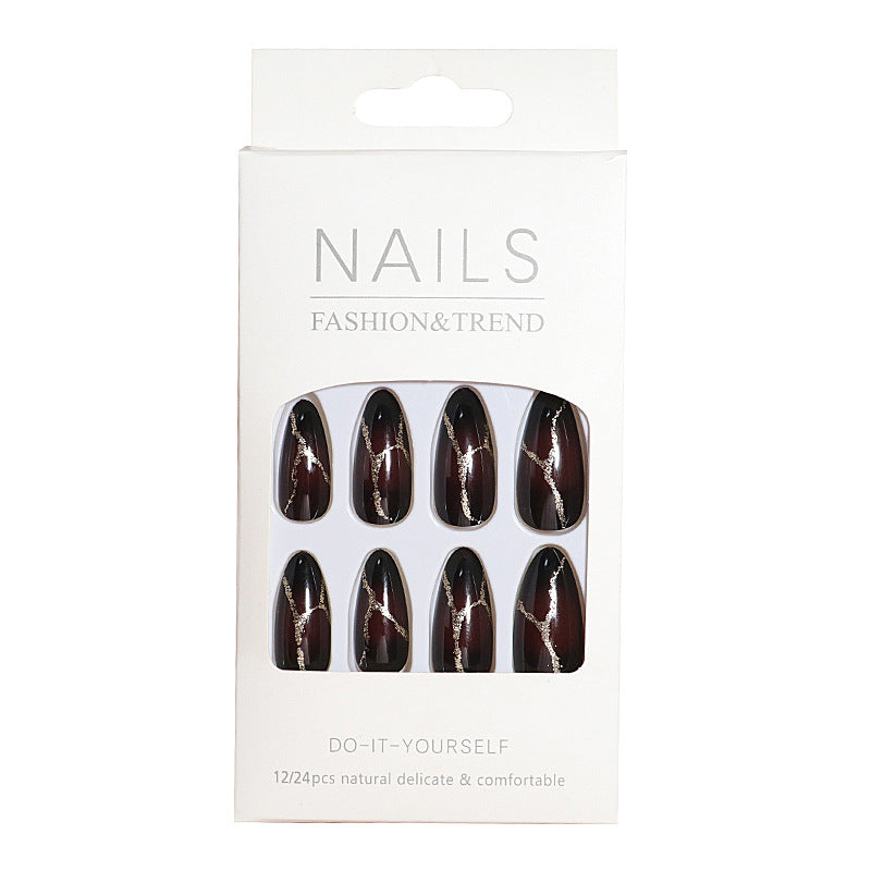 Artistic Press-On Nail Design with Gold Veining Accents Bowlift