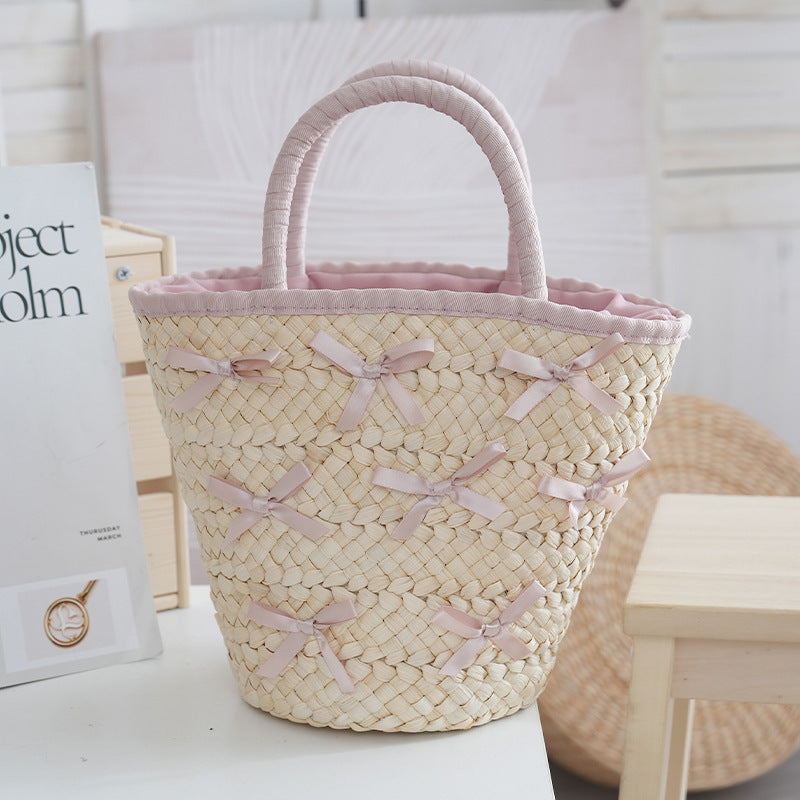 Basket bag with delicate bows and padded edge Bowlift