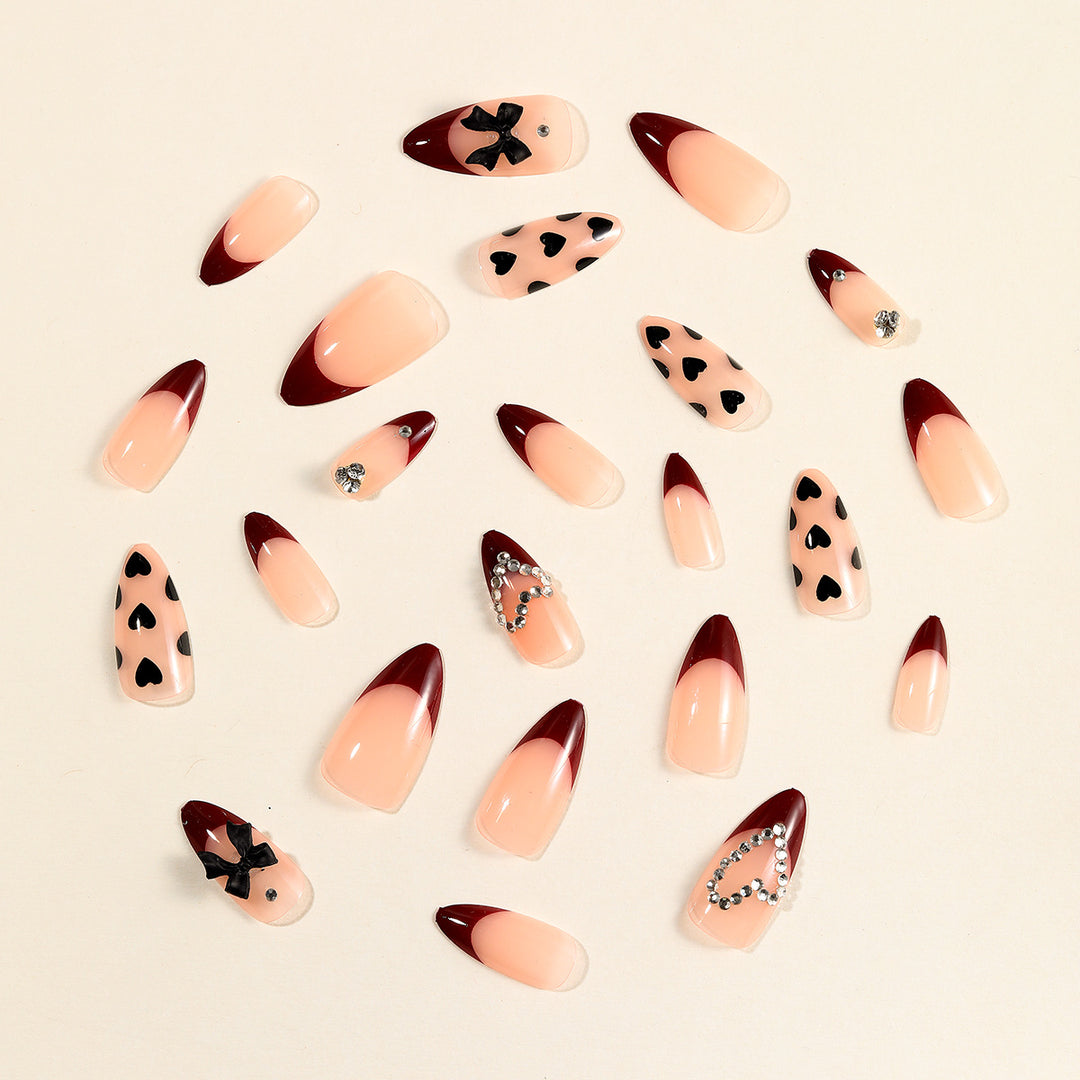 Artistic Stiletto Nail Art Extensions with Heart and Bow Accents Bowlift