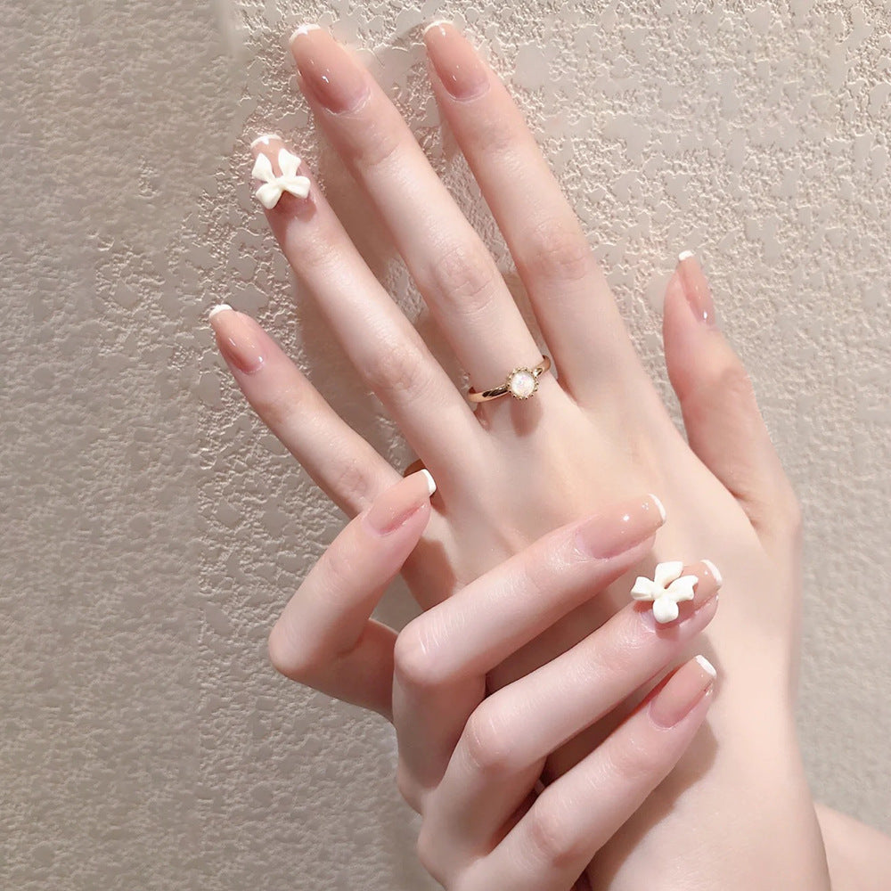 Glamorous artificial nails with heart design and glittering accents Bowlift