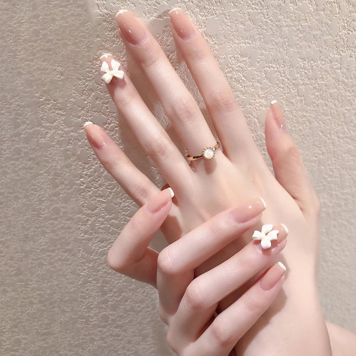 Glamorous artificial nails with heart design and glittering accents Bowlift