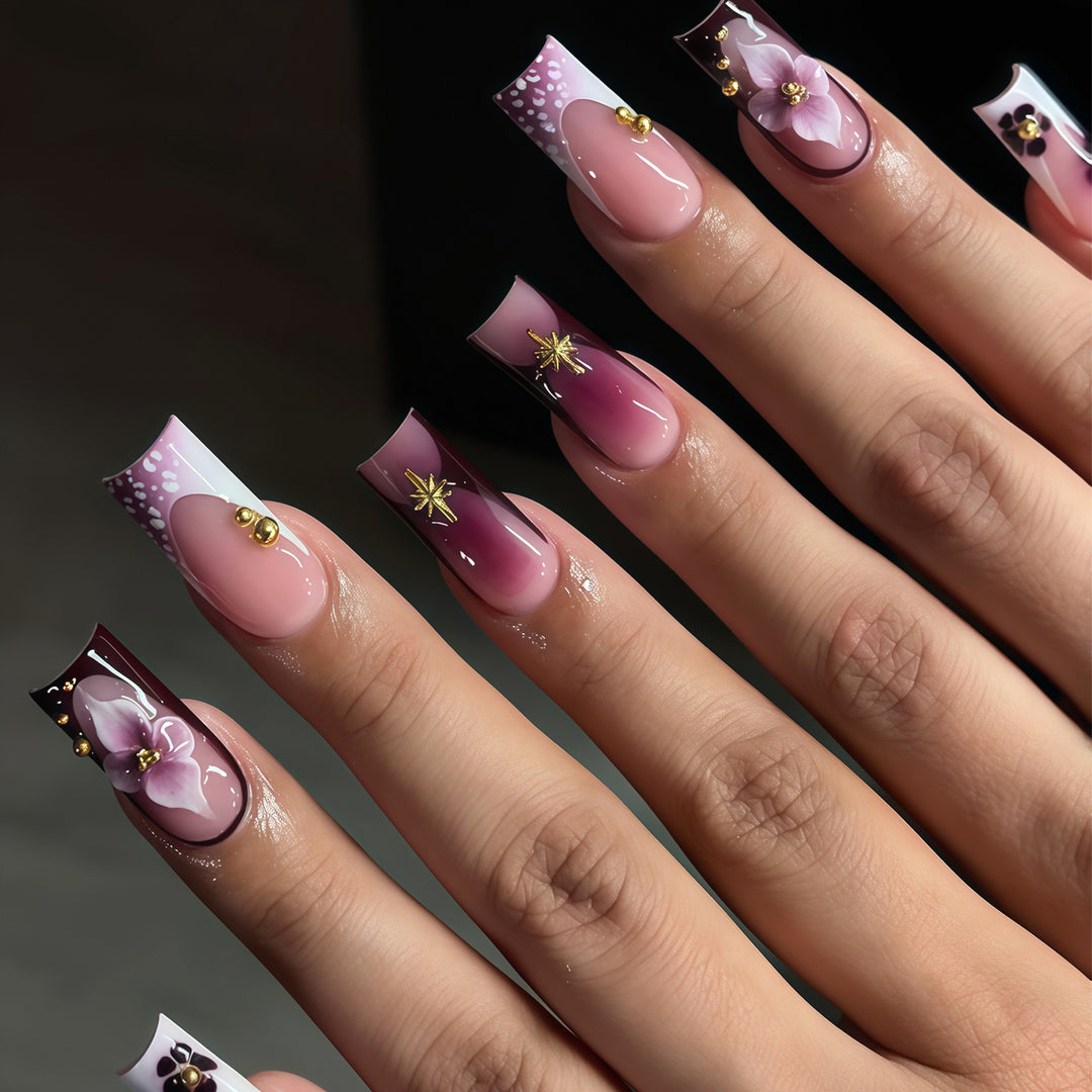 Artistic Acrylic Nail Design Set with Floral and Gold Accents Bowlift