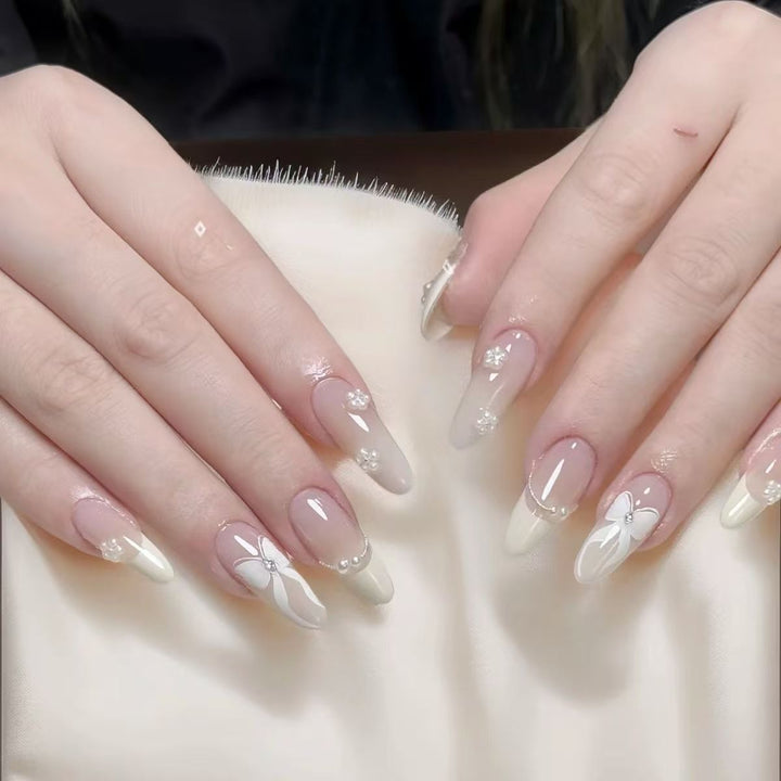 Artistic Press-On Nail Design with Decorative Silver Accents Bowlift