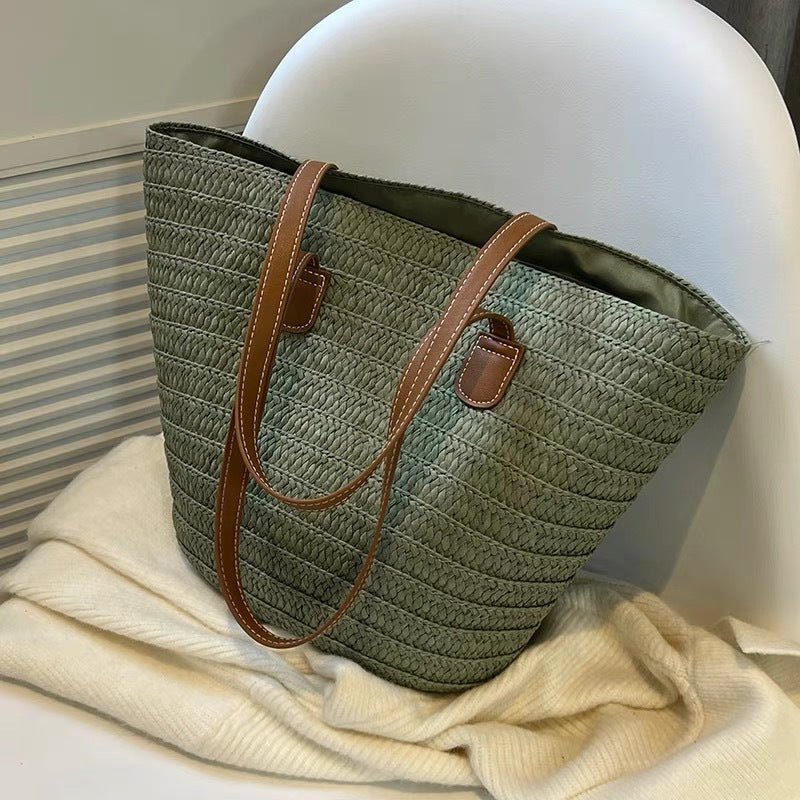 Stylish beach bag made of woven natural material with leather handles Bowlift