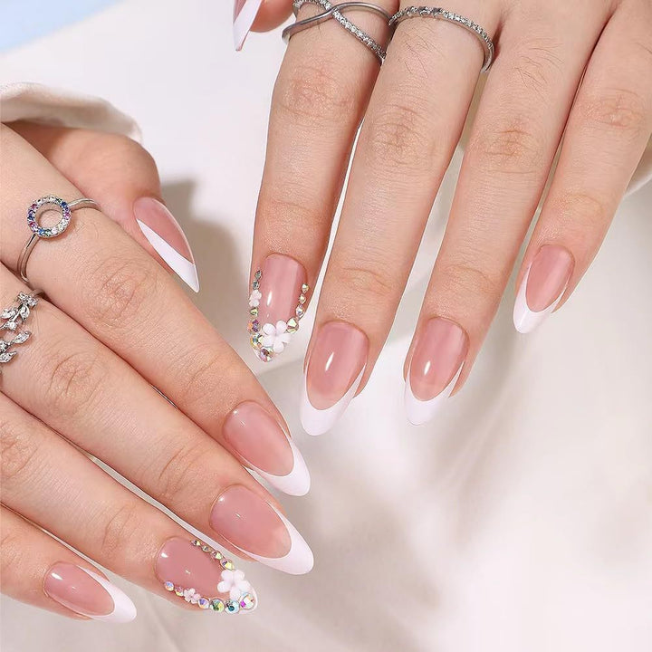 Artificial nails with elegant French tips and rhinestone details Bowlift