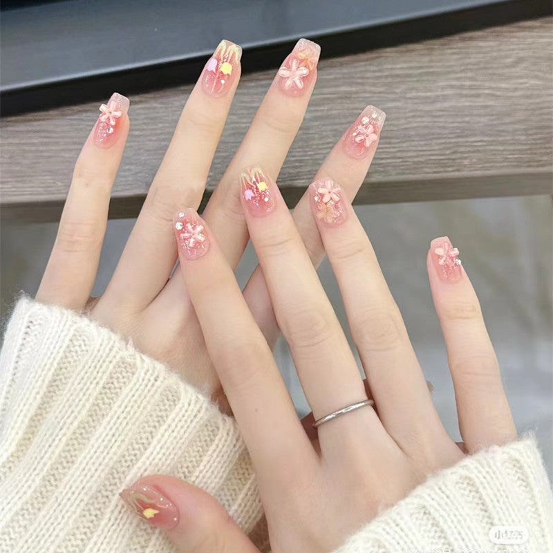 Glamorous artificial nails with delicate flower and glitter effects Bowlift