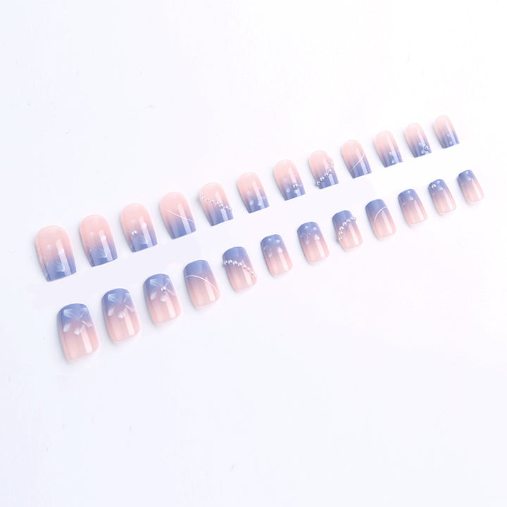 Nail set with elegant floral accents and glitter embellishments Bowlift