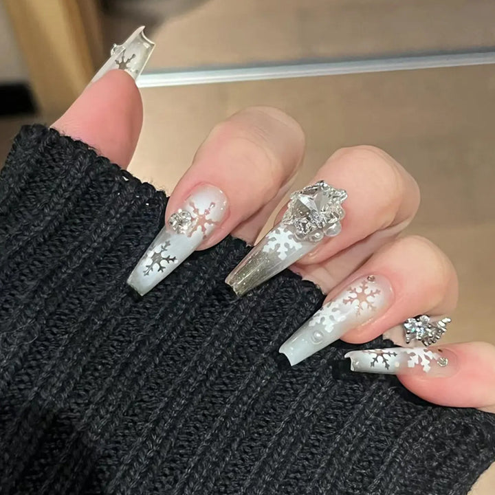 Artificial nail set with frosty snowflake design and sparkling 3D applications Bowlift