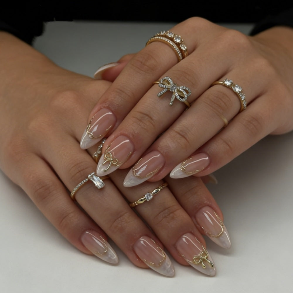 Artificial nails with elegant tip decorations and golden accents Bowlift