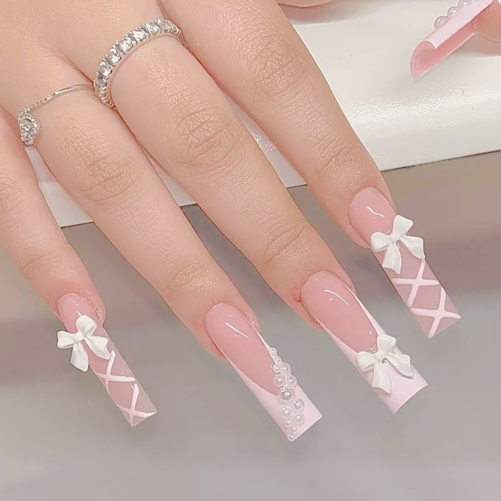 Artificial nail set with elegant 3D bows and pearl embellishments Bowlift
