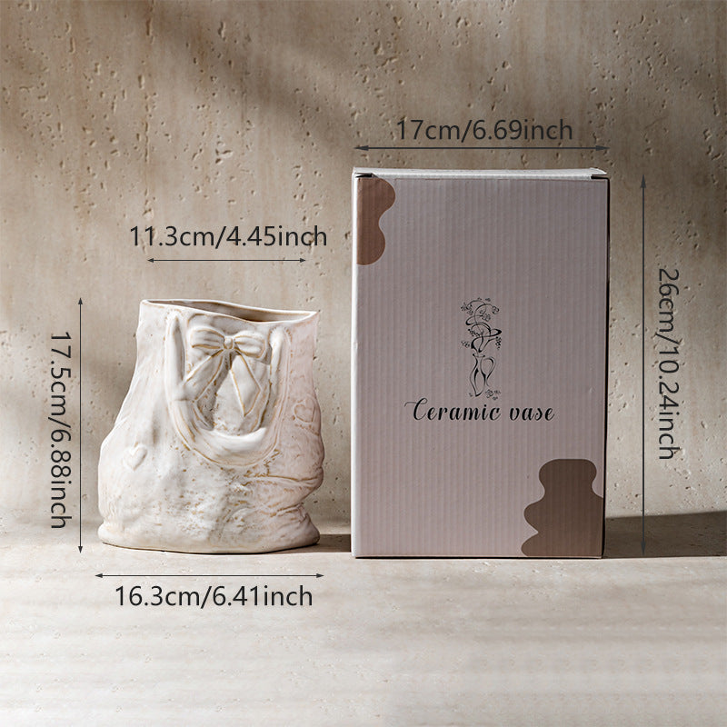 Ceramic hand-engraved bag-shaped decorative vase with bow relief and textured finish