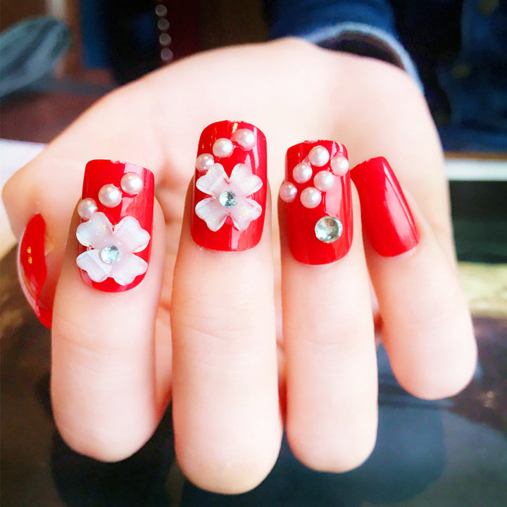 Artificials nails with sparkling rhinestone accents and elegant flower embellishments Bowlift