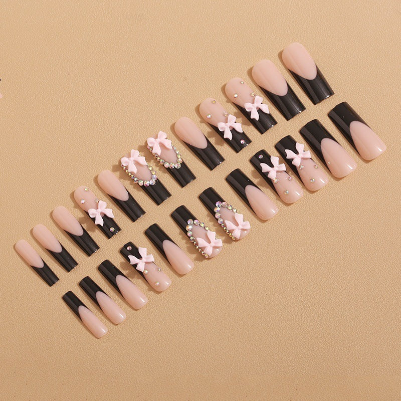 Artificial nails with elegant bows and rhinestone embellishments Bowlift