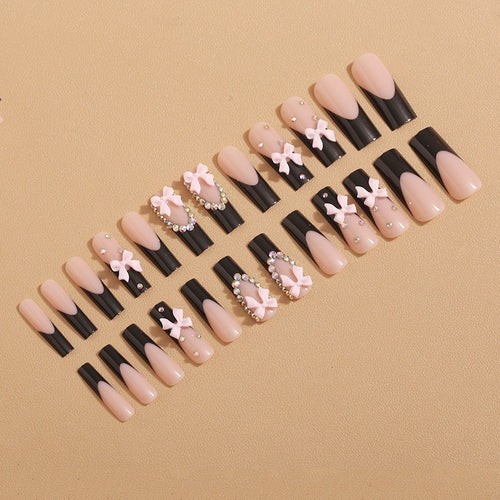 Artificial nails with elegant bows and rhinestone embellishments Bowlift