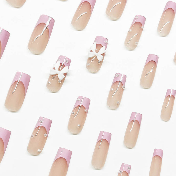 Artificial nail set with romantic bow and pearl embellishments Bowlift