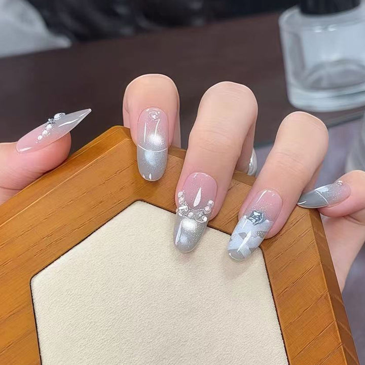 Artificial nail set with glamorous 3D details and radiant accents Bowlift