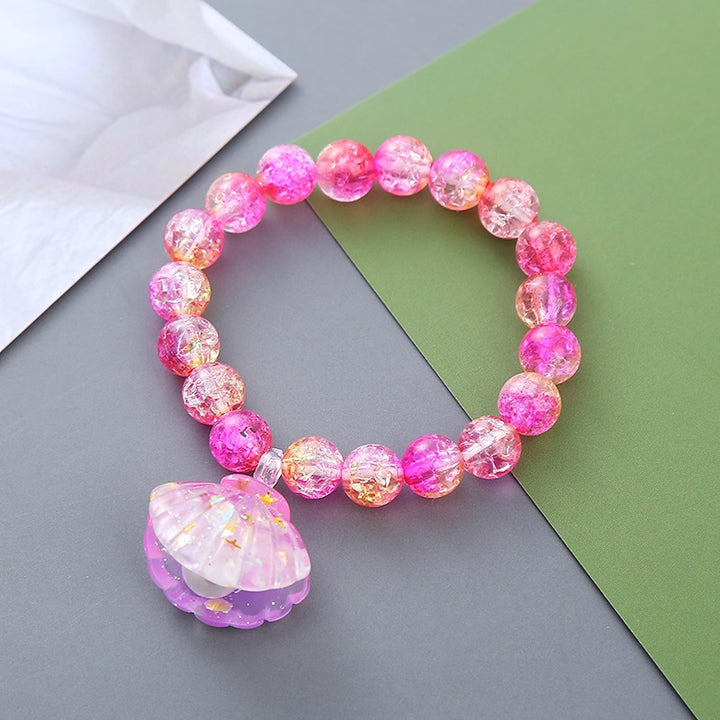 Playful bracelet with shell pendant Bowlift