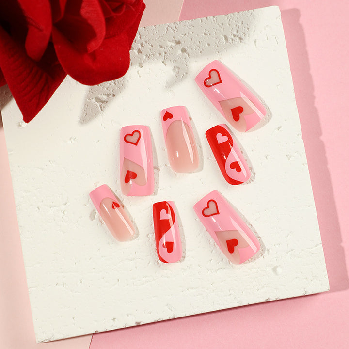 Artificial nail art with heart design and glitter accents Bowlift