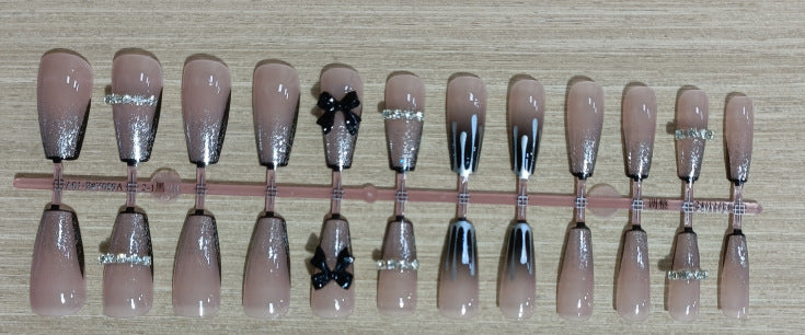 Elegant nail design with bow and rhinestone details Bowlift