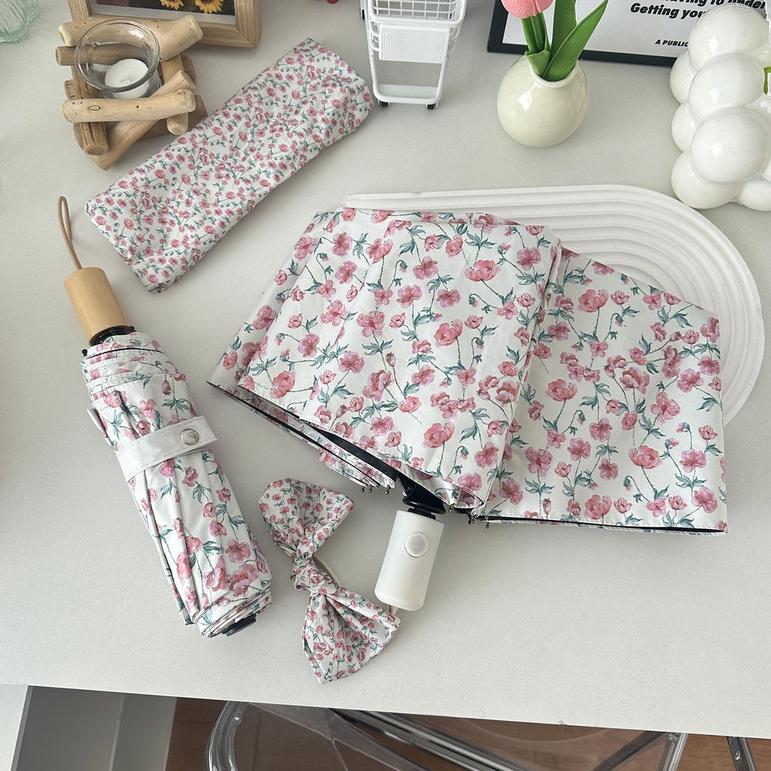 Women's folding umbrella with floral design and practical storage system Bowlift