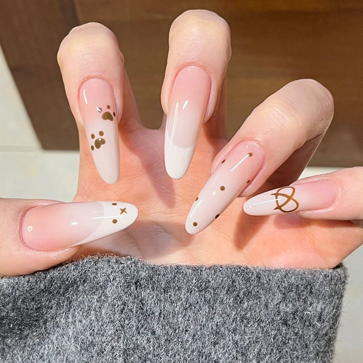 Glamorous Stiletto Press-On Nail Design with Elegant Gold Accents Bowlift