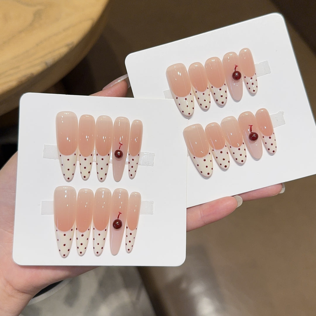Artificial nails with playful design and cherry accents Bowlift