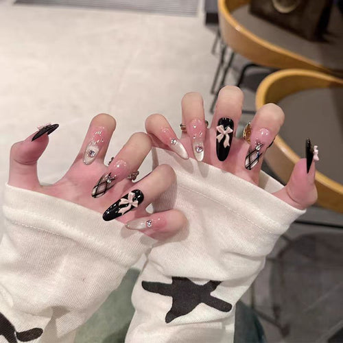 Artificial nails with playful bow and glitter accents Bowlift