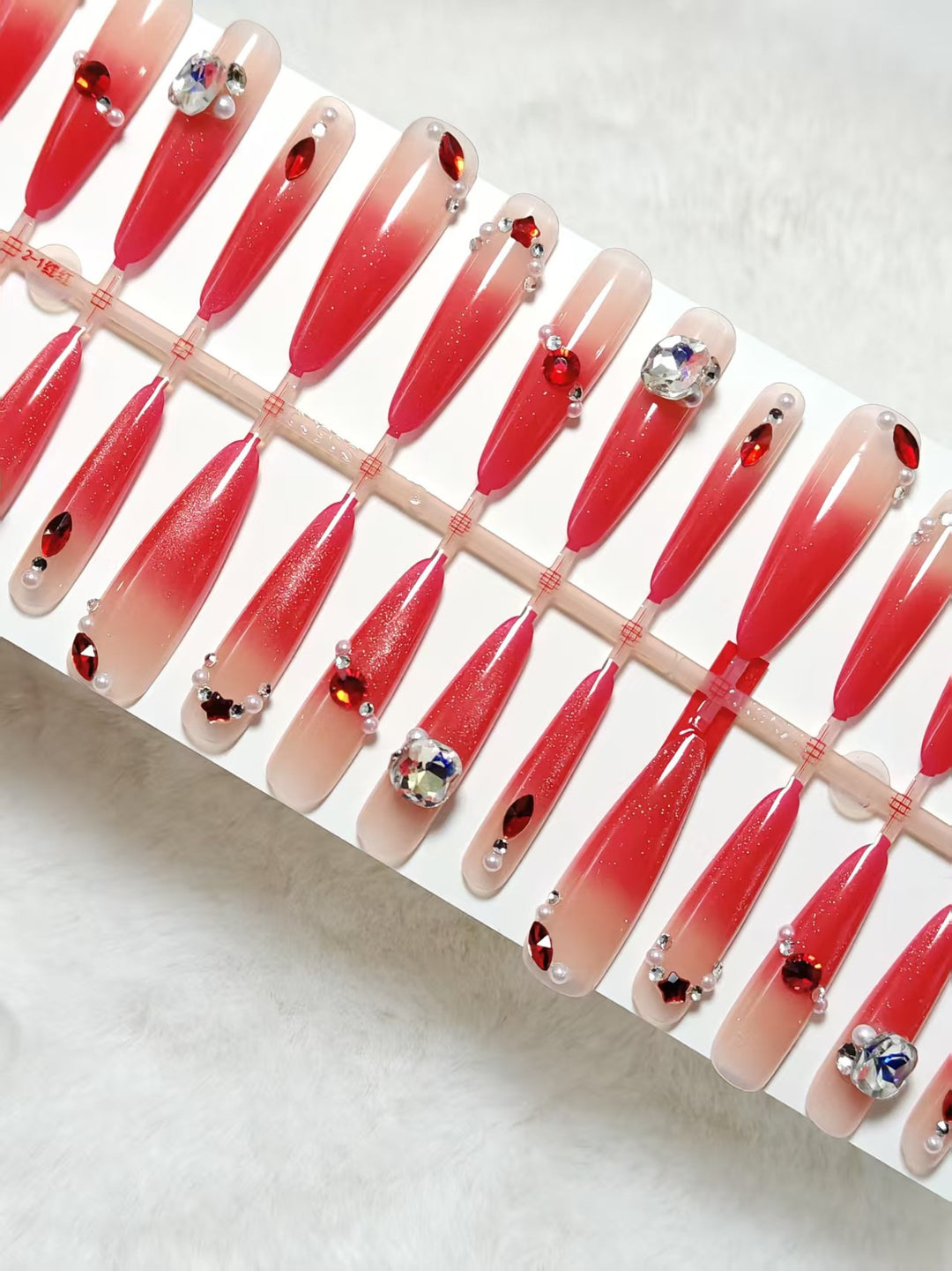 Glamorous artificial nails with sparkling ombre effect and elegant embellishments Bowlift