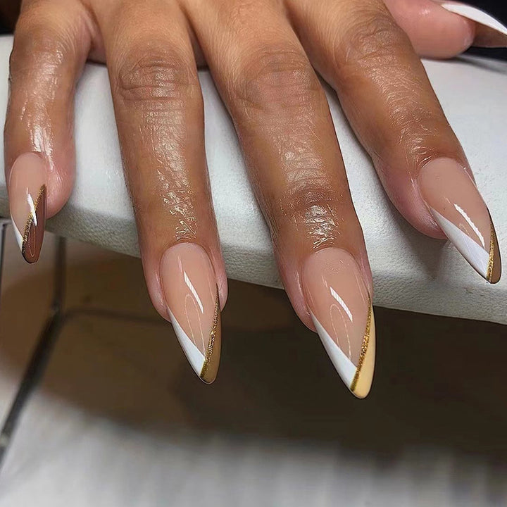 Artful nail art in elegant stiletto design with golden accents Bowlift