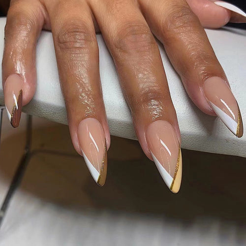 Artful nail art in elegant stiletto design with golden accents Bowlift