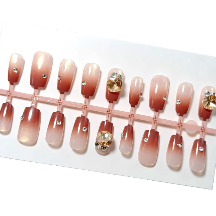 Artificials nails in elegant ombre style with rhinestone embellished applications Bowlift