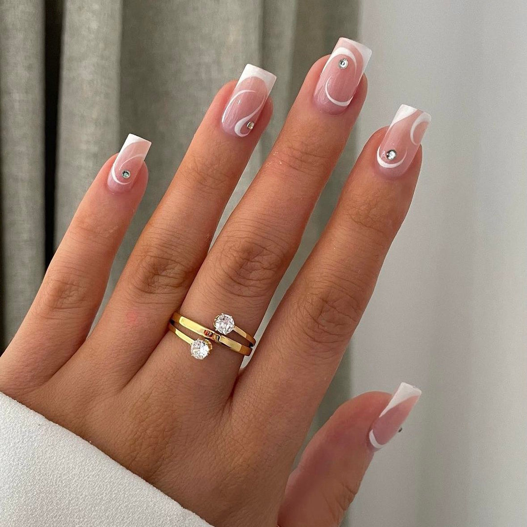 Artificial nail set with elegant French tips and glamorous rhinestone decorations Bowlift