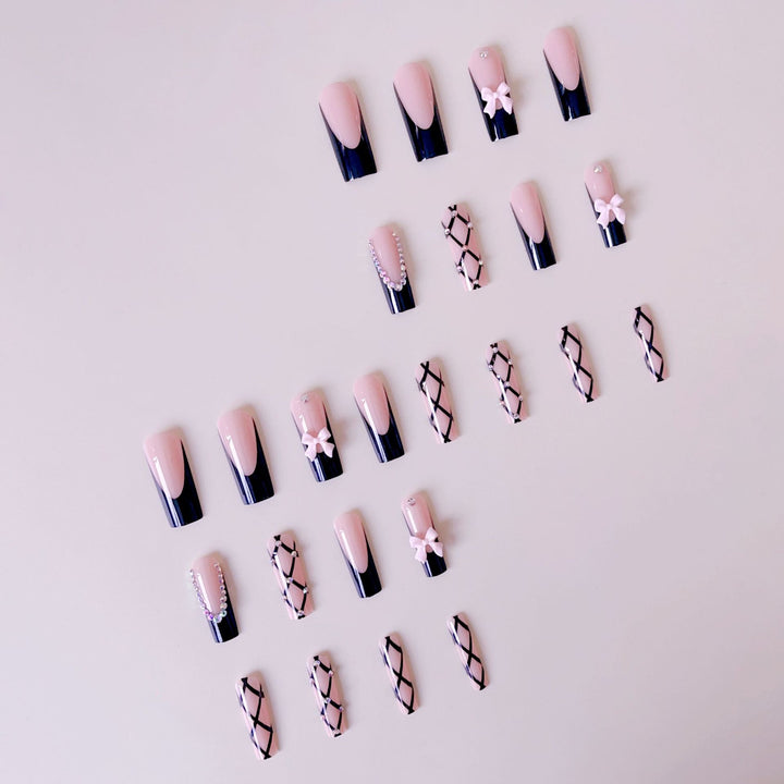 Artificial nail set with glamorous rhinestone and bow accents Bowlift