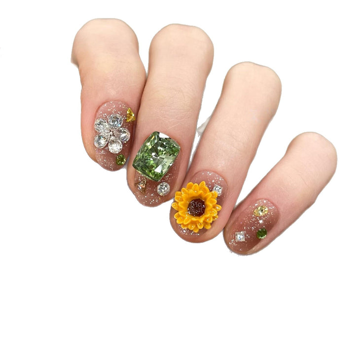 Artificial nails with sparkling appliqués and floral designs Bowlift