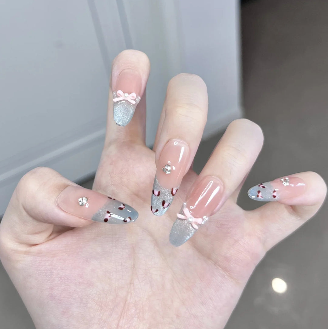 Artistic Press-On Nail Design with Floral and Gemstone Accents Bowlift