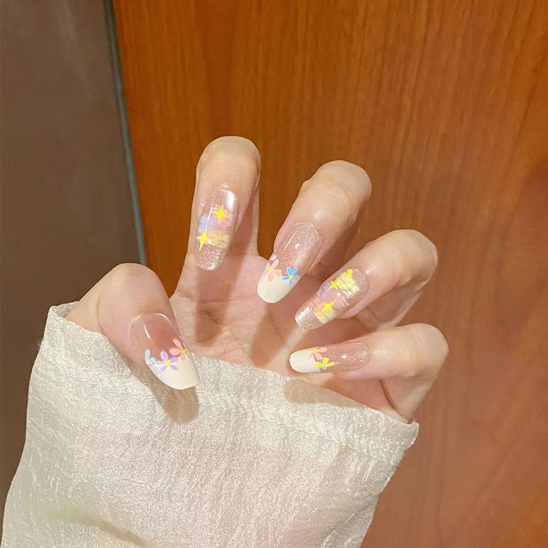 Artificial nails with delicate floral accents and glitter effects Bowlift
